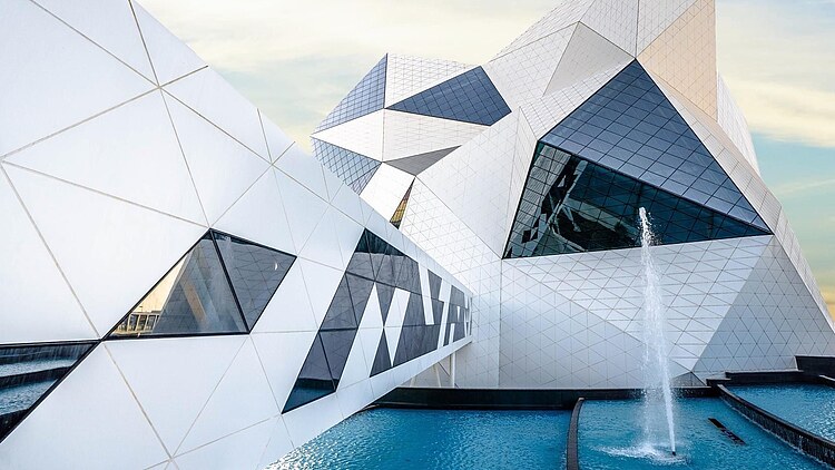 Crystal-Shaped building of the Sky Venture facility on Yas Island, featuring a white facade and large glass surfaces