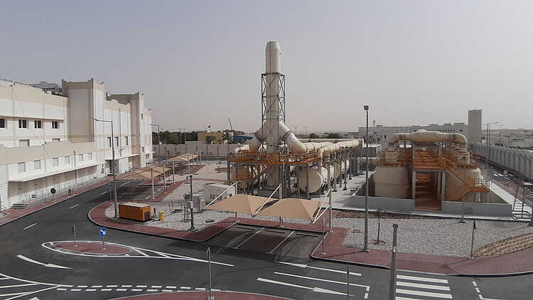 View of the completed pumping station at Doha South Terminal, featuring large pipelines and sourrounding infrastructure