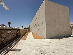 Renovated Al Ain Museum building with a light stone facade and outdoor area