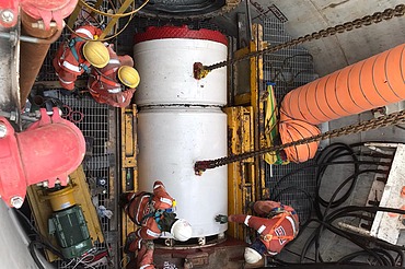 A work crew lowers a large tunnel boring machine segment into a construction shaft for the CTSS Phase 2 Link Sewer Project